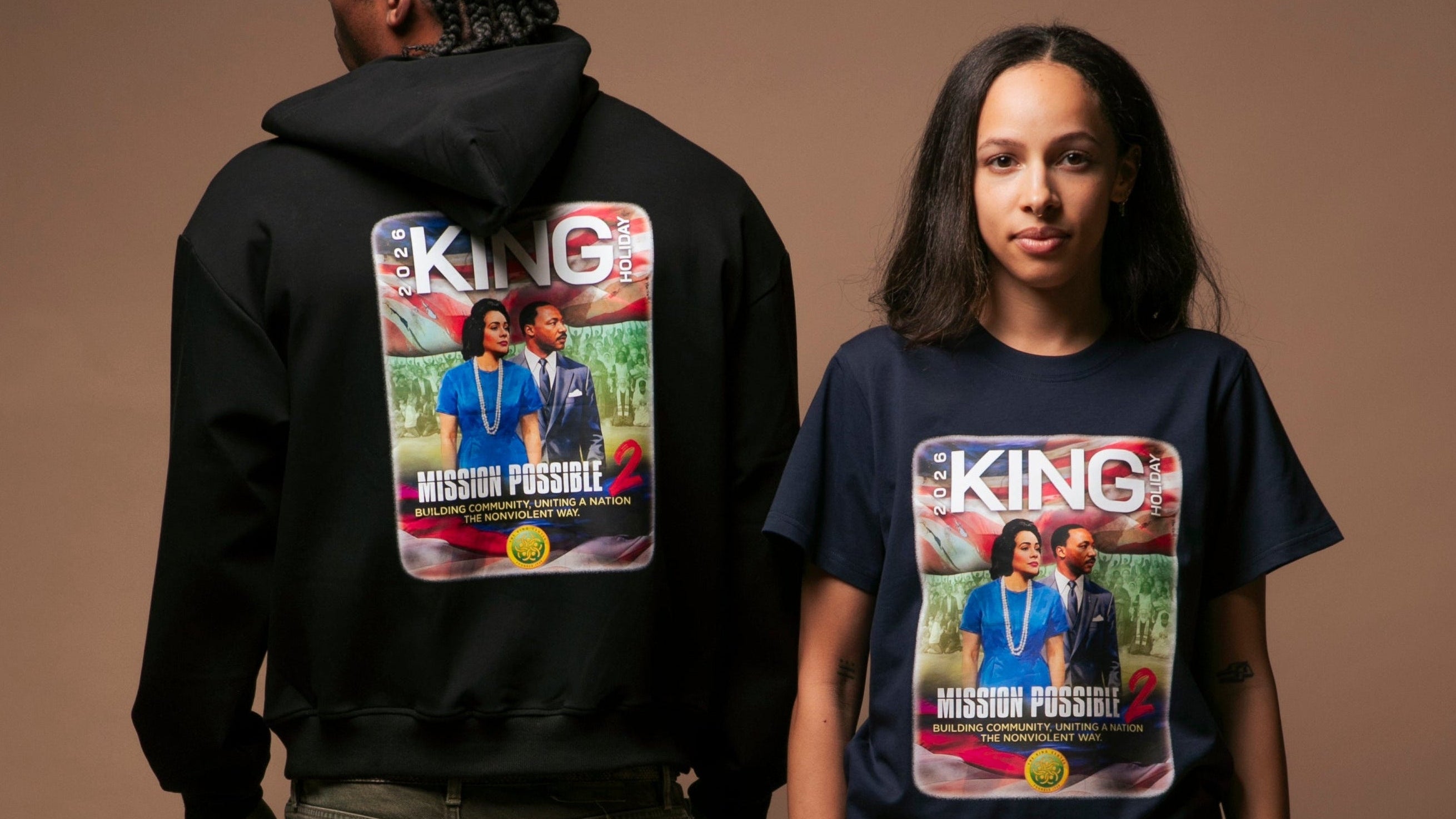 Two people wearing hoodies and t-shirts with a graphic design on a brown background